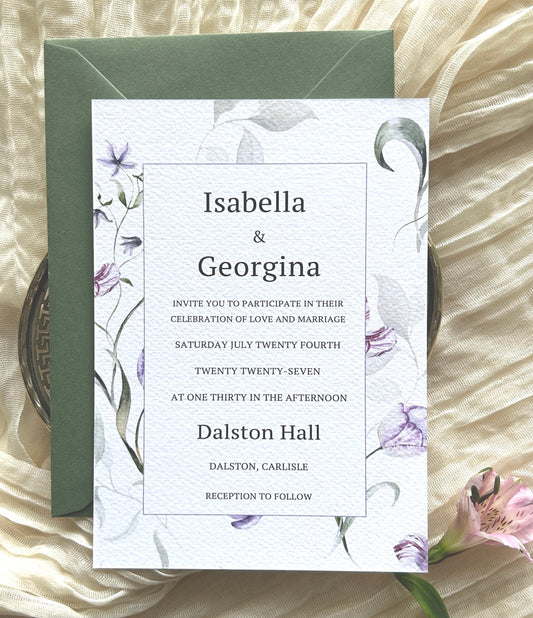 Wedding invitation card with lilac and green floral designs with a green envelope
