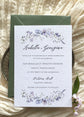 Wedding invitation card with blue, purple and pink floral design on a textured surface with green envelope
