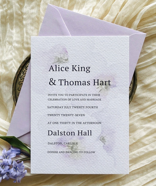 Wedding invitation card with a soft, watercolour floral design, modern font and a lilac envelope
