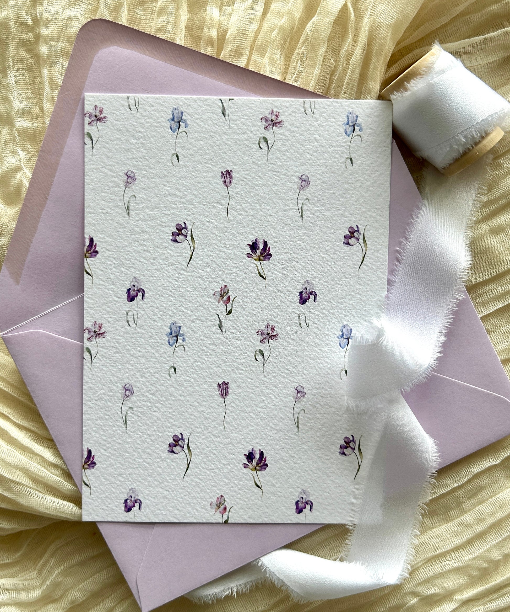 reverse of a 5x7' invitation with blue and pink flowers